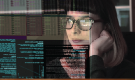 A picture containing a pretty young woman analyzing data on a computer screen