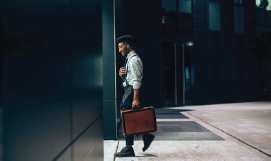 A picture 
    containing a man exiting an office building