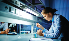 A picture containing a female scientist working in a 
                           laboratory