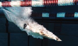 A 
person diving into a swimming pool