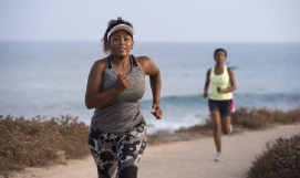 A 
    picture containing 2 women running